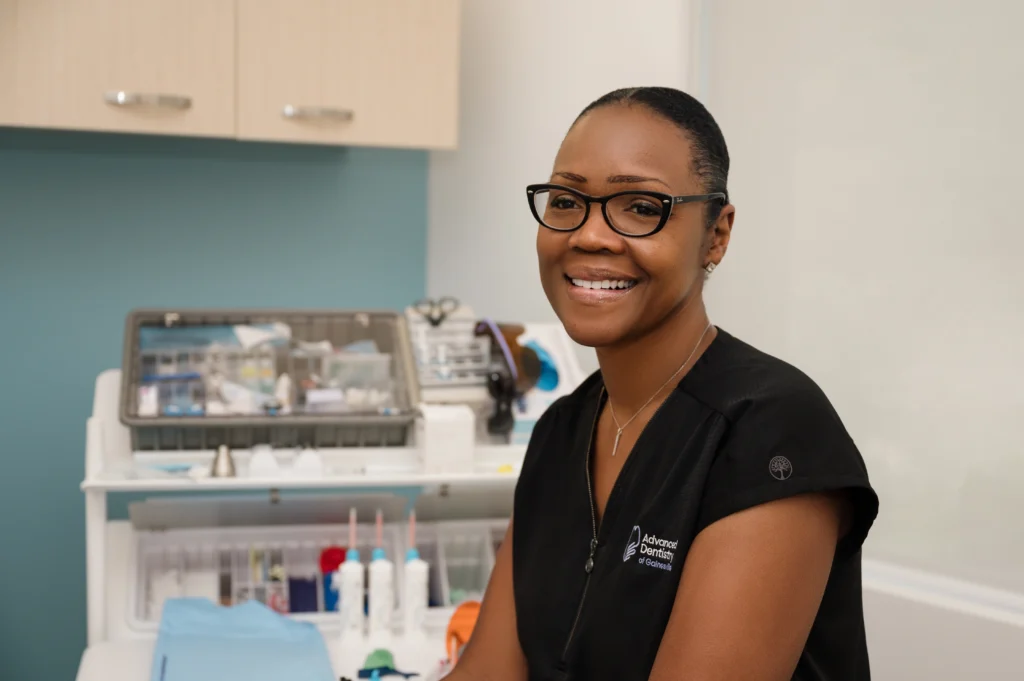 Tangela sitting in an exam room smiling