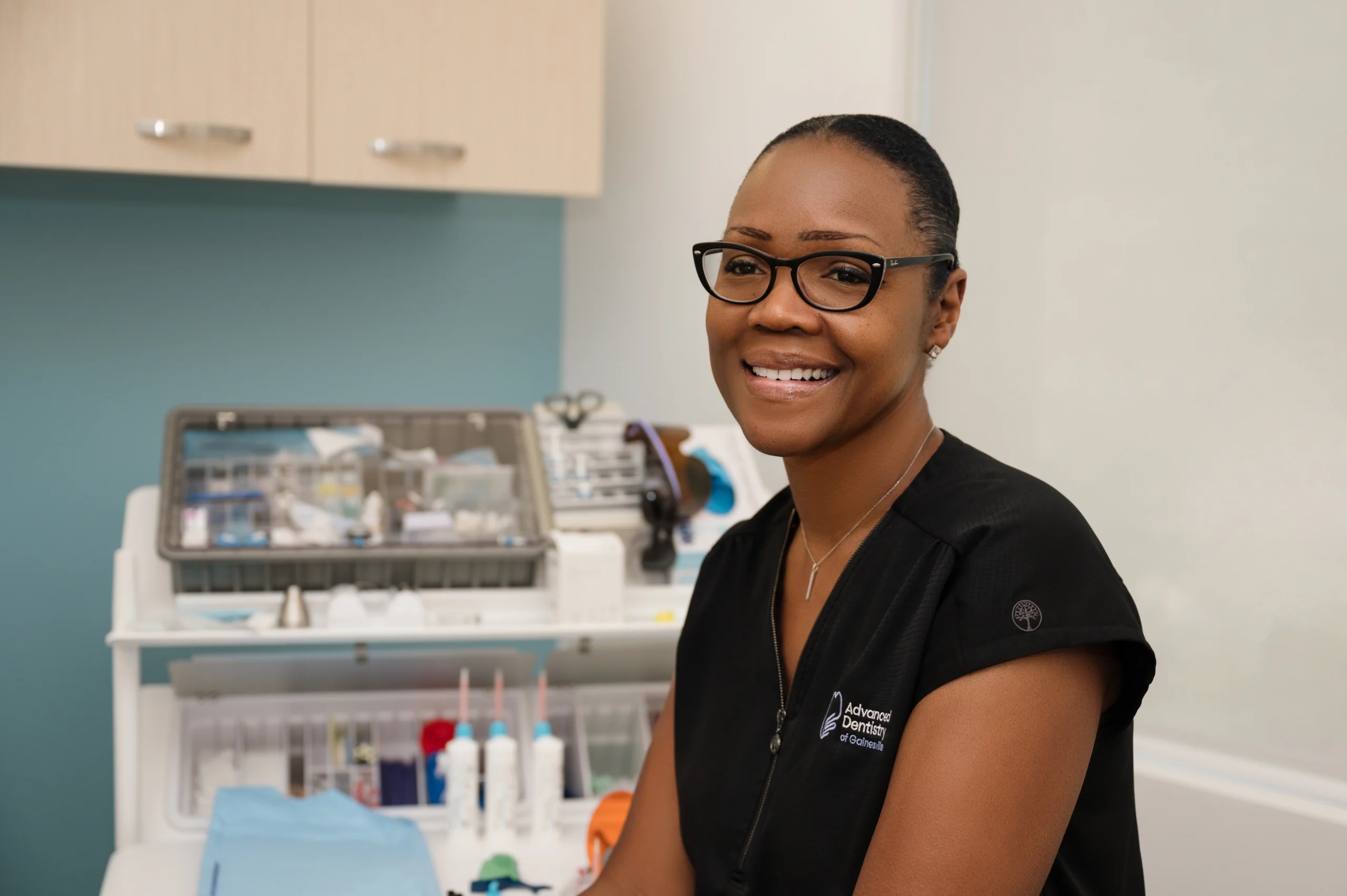 Tangela sitting in an exam room smiling