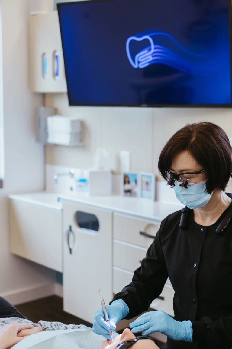 A skilled hygienist helps a patient by removing calculus buildup on their teeth.